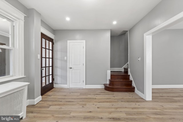 entryway featuring recessed lighting, baseboards, wood finished floors, and stairs