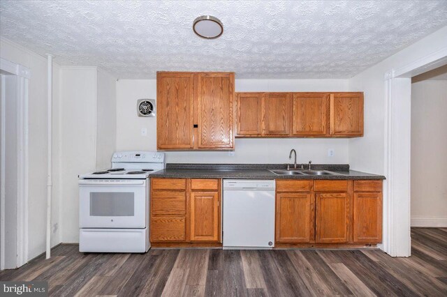 kitchen with a sink, visible vents, white appliances, and brown cabinetry