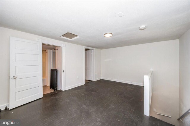 empty room with baseboards and wood finished floors