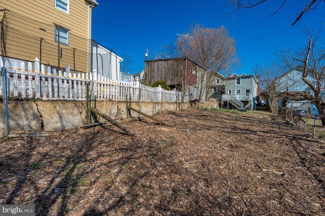 view of yard with stairway and fence