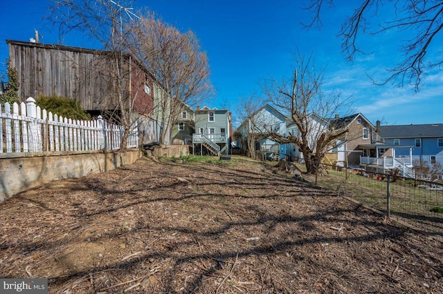 view of yard with a residential view and fence