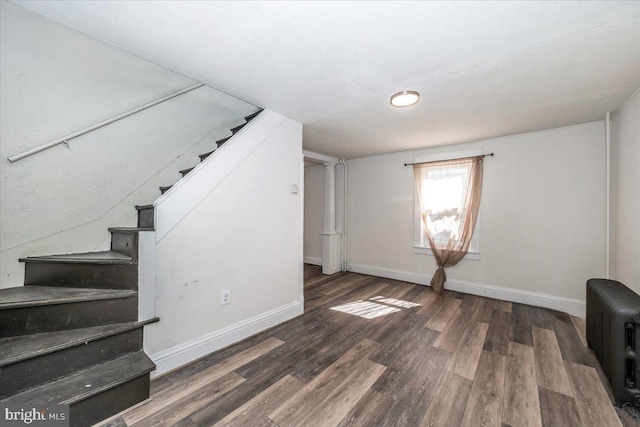 interior space featuring baseboards, radiator, and wood finished floors