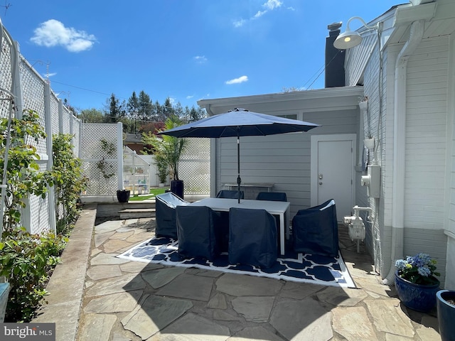 view of patio / terrace featuring fence and outdoor dining area