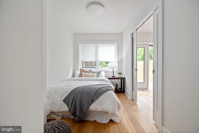 bedroom with light wood-style floors and baseboards