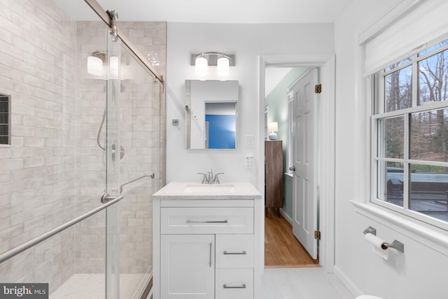 full bathroom with a stall shower and vanity