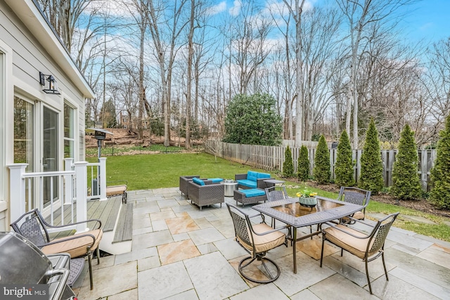 view of patio / terrace featuring outdoor dining space, an outdoor living space, and a fenced backyard