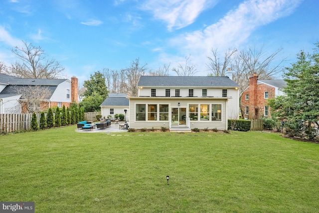 back of house featuring a patio area, a yard, and fence