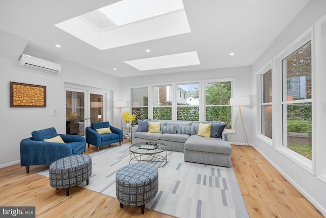 living room featuring a wall unit AC, recessed lighting, french doors, a skylight, and wood finished floors