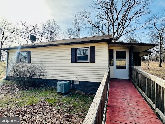 exterior space with central air condition unit and crawl space