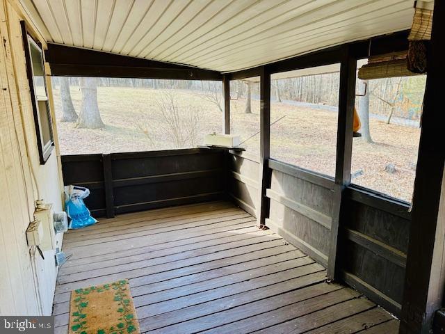 unfurnished sunroom with a wealth of natural light and wooden ceiling