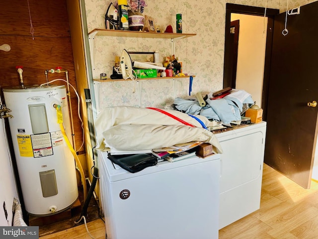 clothes washing area with water heater, laundry area, wallpapered walls, and wood finished floors