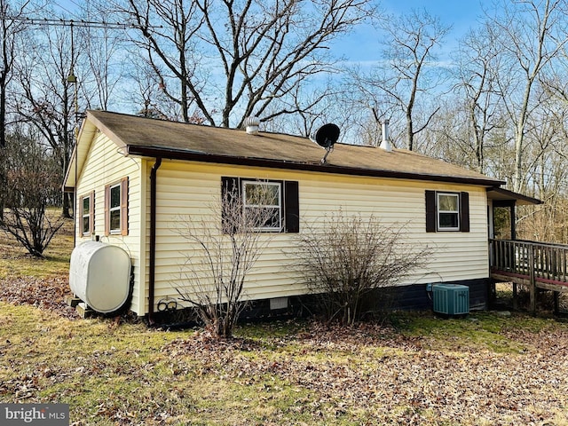 view of property exterior with crawl space, heating fuel, and central AC