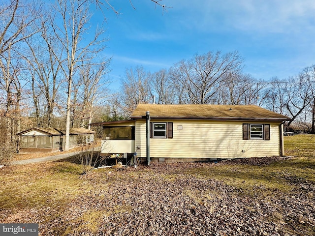 rear view of house with crawl space and a sunroom