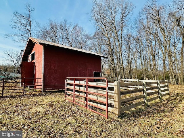 view of outbuilding with an outbuilding and fence