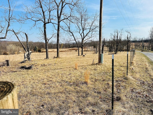 view of yard with a rural view