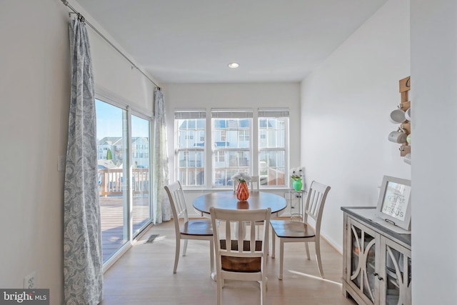 dining area featuring recessed lighting, wood finished floors, and baseboards