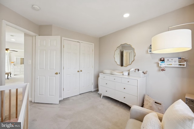 bedroom featuring recessed lighting, light colored carpet, and a closet