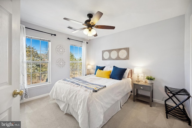 carpeted bedroom with a ceiling fan, baseboards, and visible vents