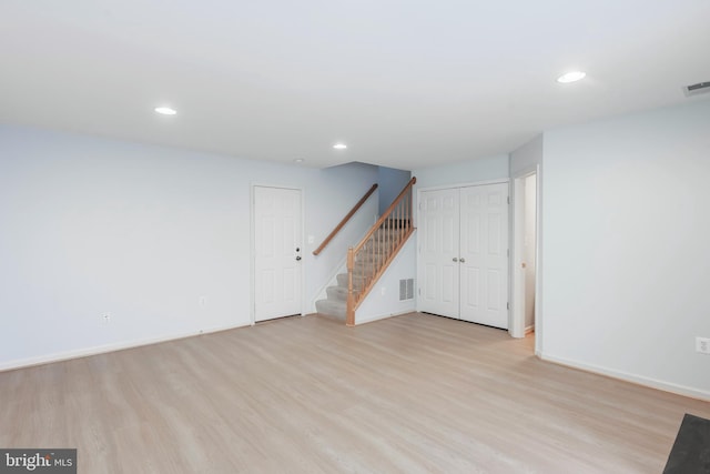 unfurnished living room with recessed lighting, stairway, visible vents, and wood finished floors