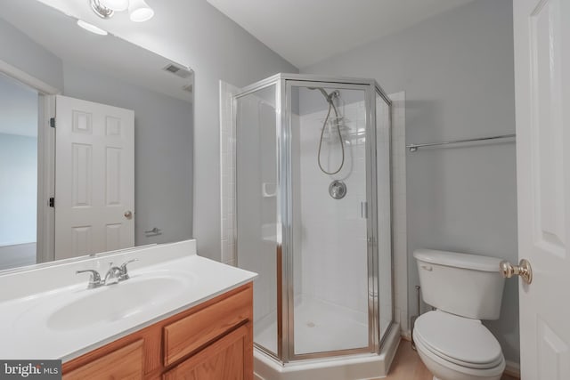 bathroom with visible vents, toilet, a stall shower, and vanity