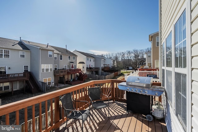 deck featuring area for grilling and a residential view