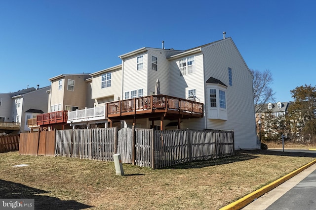 rear view of house with a yard, a residential view, and fence