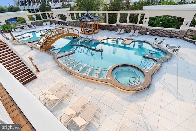 pool featuring a patio and a community hot tub