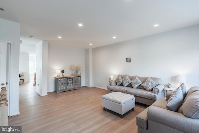 living area with recessed lighting, baseboards, and light wood-style floors