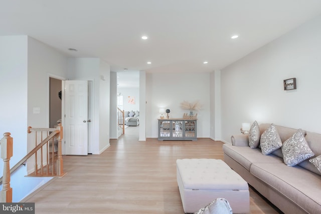 living room with recessed lighting, light wood-type flooring, and baseboards