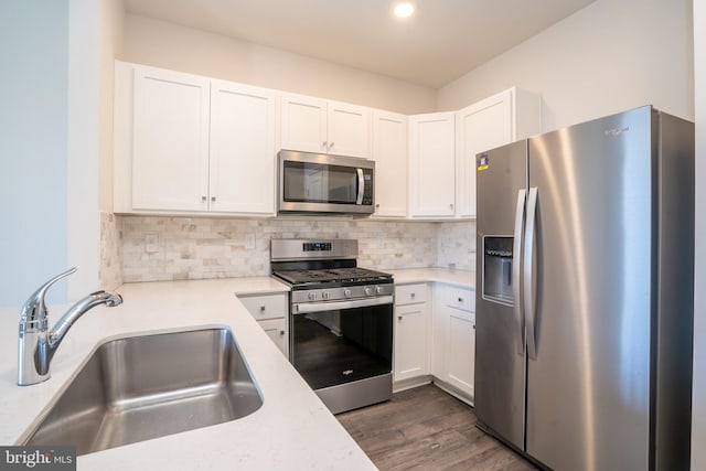 kitchen featuring a sink, light countertops, tasteful backsplash, and stainless steel appliances