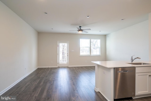 kitchen with stainless steel dishwasher, open floor plan, and a sink