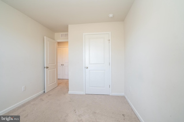 unfurnished bedroom featuring visible vents, baseboards, and carpet floors