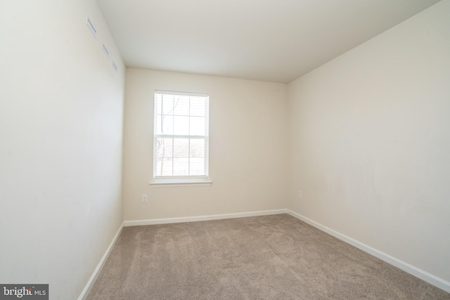 unfurnished room with baseboards and carpet floors