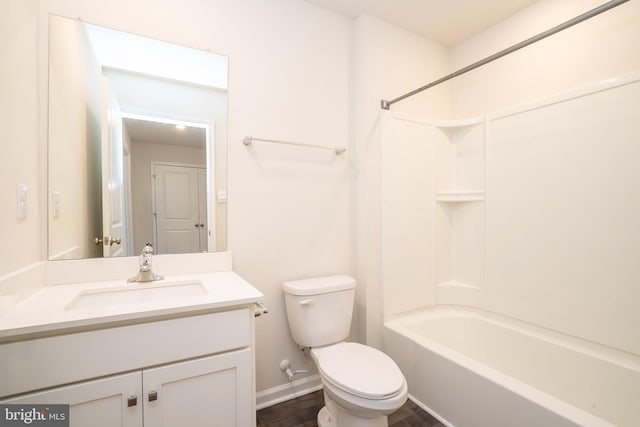 full bath with bathing tub / shower combination, baseboards, toilet, and vanity