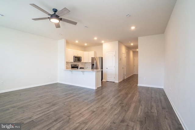 unfurnished living room with recessed lighting, a ceiling fan, baseboards, and dark wood-style flooring