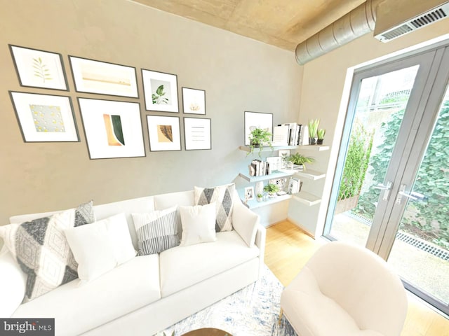 living room with visible vents, wood finished floors, and french doors