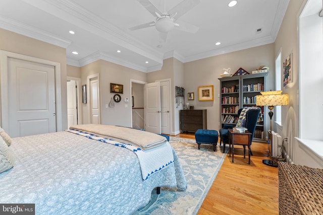 bedroom with visible vents, recessed lighting, crown molding, and light wood-style floors