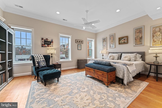 bedroom with visible vents, multiple windows, and ornamental molding