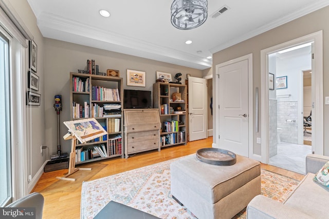 living room with visible vents, baseboards, ornamental molding, recessed lighting, and wood finished floors