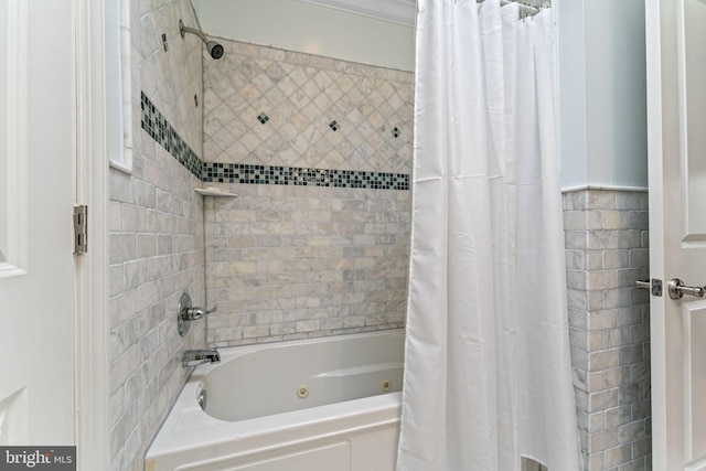 bathroom with a combined bath / shower with jetted tub