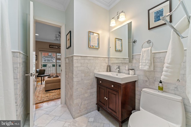 full bathroom with tile walls, toilet, and ornamental molding