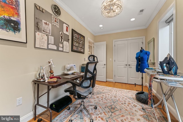 office area with crown molding, wood finished floors, baseboards, and visible vents