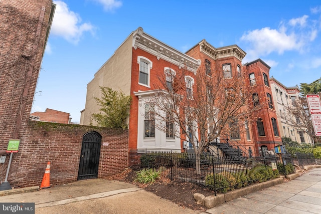 view of building exterior with a fenced front yard