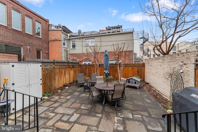 view of patio featuring outdoor dining area and a fenced backyard