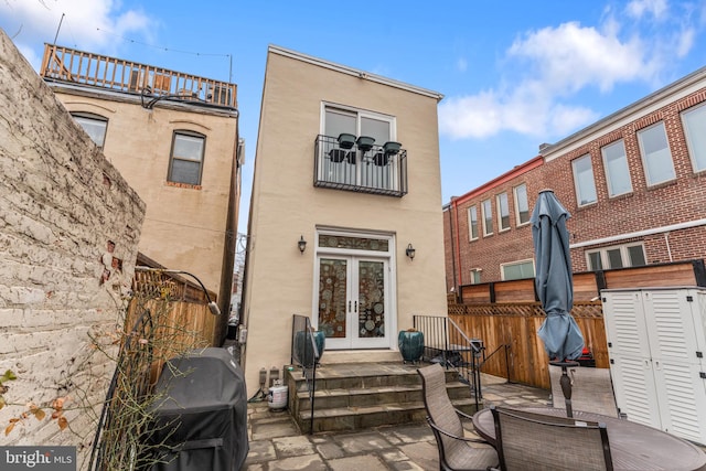 back of property featuring a patio area, french doors, fence, and stucco siding