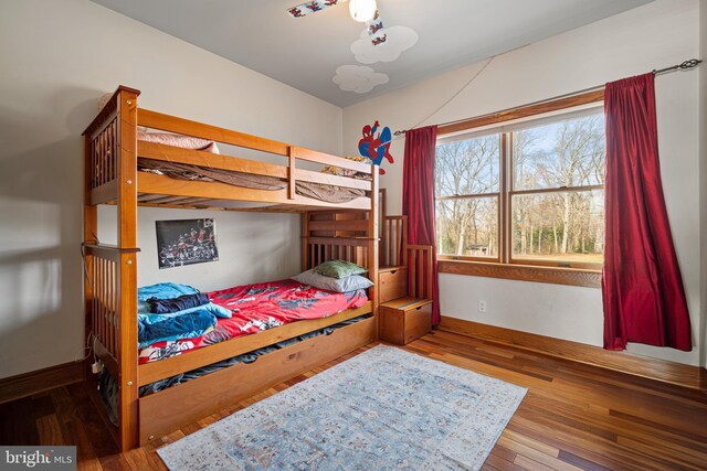 bedroom featuring baseboards and wood finished floors