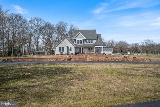 view of front of home with covered porch and a front yard
