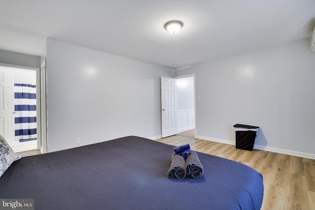 bedroom featuring baseboards and wood finished floors