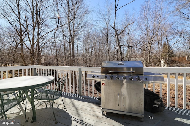 deck featuring grilling area and outdoor dining area