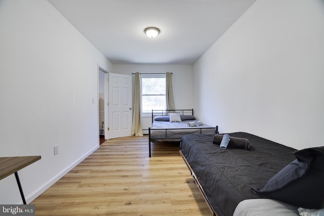 bedroom featuring light wood-style flooring and baseboards